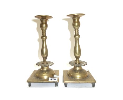 A pair of 18th century bronze candlesticks with a pierced collar 25cm high, an English brass candlestick circa 1710 with octa