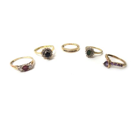 An 18ct gold, sapphire and diamond set cluster ring, a 9ct gold, ruby and diamond set three stone ring, a 9ct gold and diamon