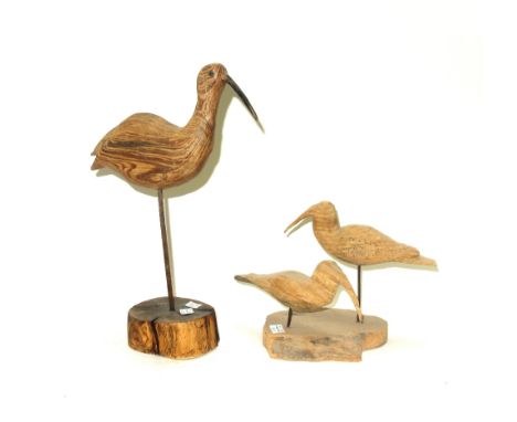 Two polychrome painted decoy ducks, circa 1930, papier mâché and pine, 34cm wide, a painted cast iron duck, a painted sheet m
