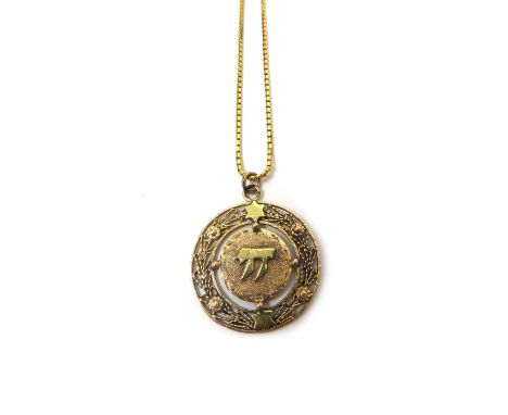 A two colour gold circular pendant, decorated with Stars of David, and with Hebrew lettering, detailed 14 K, weight 9.5 gms, 