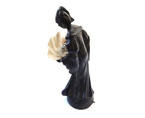 An Art Deco style bronze figural lamp, 20th century, modelled as a woman in a bonnet and long flowing dress, the shade formed