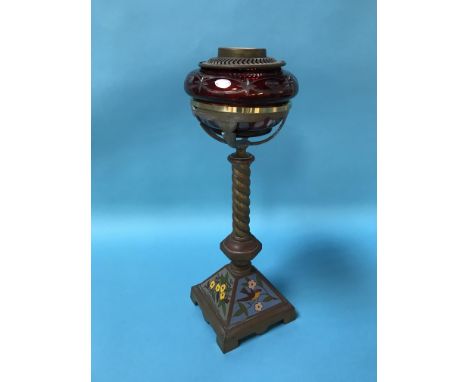 An oil lamp, with ruby coloured reservoir