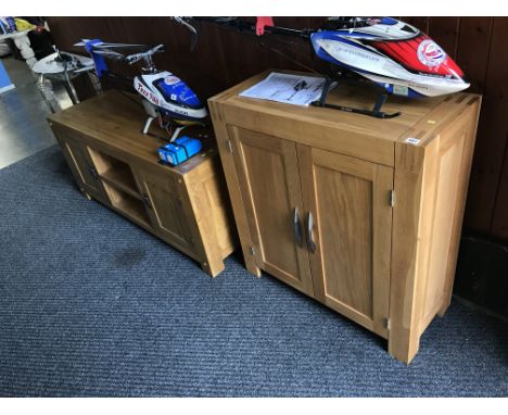 A light oak base unit and a small two door cabinet