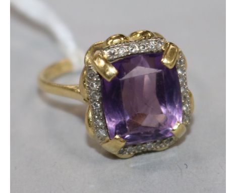 An 18ct gold, amethyst and diamond set dress ring, size M.