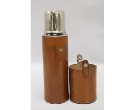 A silver plated flask in leather case