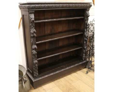 A late Victorian carved oak open four shelf bookcase W.107cm