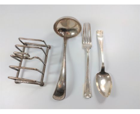 A Dutch ladle, American spoon and fork. London toast rack 