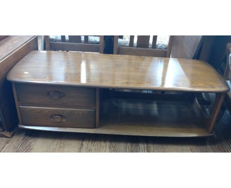 An Ercol Pandora coffee table. circa 1970. 40cm x 123cm x 53xm 