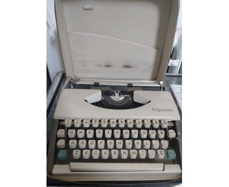 An Olympia De Luxe typewriter in a zipped case. 