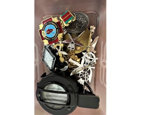 A small collection of modern military badges, and a compass 