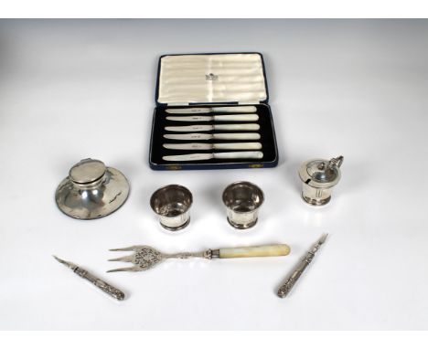 to include a weighted capstan inkwell by Asprey &amp; Co Ltd, Birmingham, 1912; three piece cruet set; M.O.P handle bread for