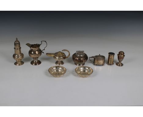 to include a pair of pierced dishes, oil lamp table lighter, two pepper pots, one large pepper pot, milk jug, one salt with b