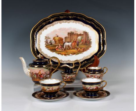 all painted with figures in rural scenes, comprising teapot, sugar bowl, milk jug, two tea cups and saucers and oval tray 14¼