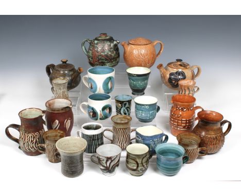 in varying styles, sizes and colourways, to include four teapots, four large milk jugs and sixteen cups / mugs. (24)* Provide