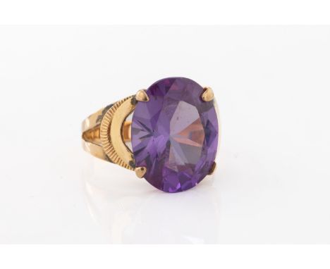 set with a fancy-cut amethyst with decorative shoulders, ring size M.