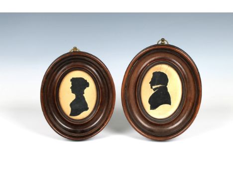 on paper, depicting a lady and gentleman, each frame in deep wooden oval frames, 5¾in. (14.7cm.) long, unmarked. (2)* Overall