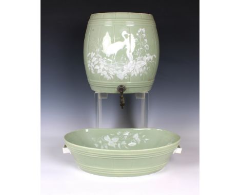 the reservoir in the form of a barrel decorated with storks with a basin beneath, brass tap, 20in. (50.8cm.) high. (2 parts)*