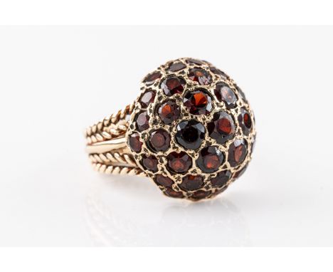 set with garnets of various sizes in rose metal, unmarked, ring size K.
