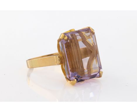 the step-cut amethyst claw-set in a yellow mount, ring size M, unmarked.