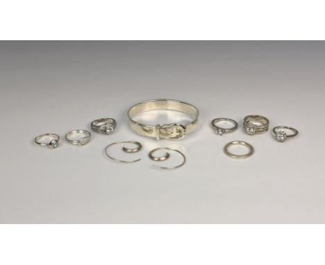 to include a silver hinged bangle with buckle detailing, a pair of silver earrings and seven silver stone-set rings. (10)