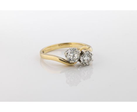 set with two brilliant-cut diamonds, to a wavy band, ring size K.