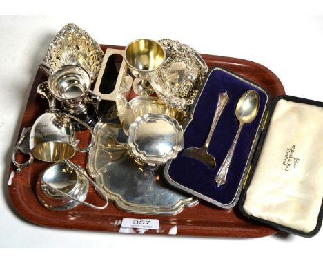 A selection of silver items consisting of a desk inkwell; a matchbox holder; a pair of pierced dishes; a 'Port' spirit label;