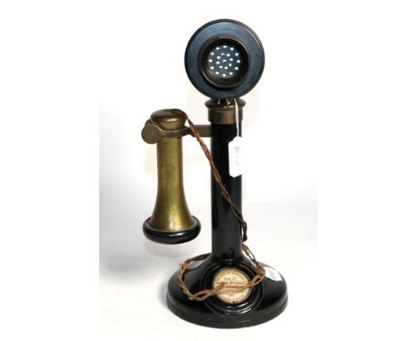 A vintage brass and bakelite stick telephone