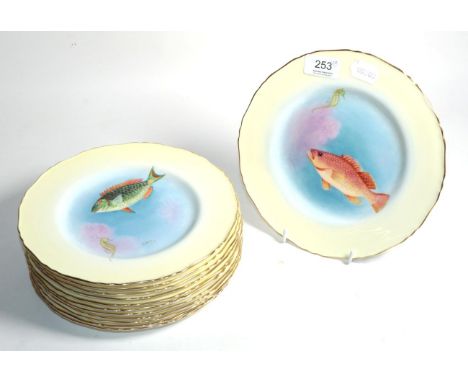 A set of twelve Royal Worcester plates each hand painted with fish, signed H Ayrton, all dated 1934 with gilt rims, each titl