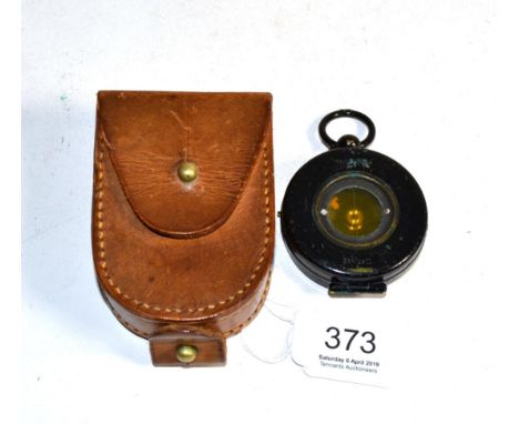 A hunters compass in a leather case 