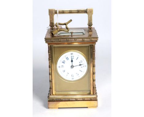 An early 20th century French brass repeater carriage clock, 8 day striking movement, circular white enamel Roman &amp; Arabic