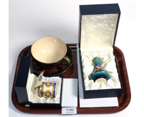 Moorcroft pottery pomegranate pattern early cup with associated saucer; a Moorcroft enamel vase, original box; and a similar 