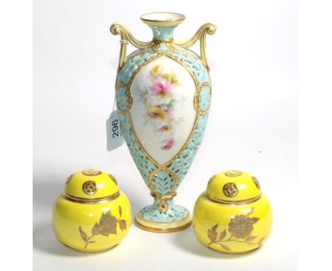 A Royal Worcester reticulated vase, with hand-painted floral panels and scrolled handles, the base numbered 963, 21cm high; a