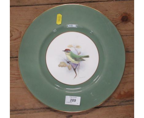 A Royal Worcester plate, decorated with a bird, signed M.Hawker