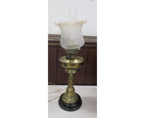 A brass oil lamp, with glass shade