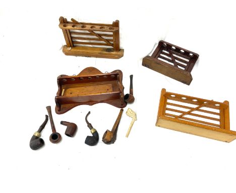 Vintage wooden smking pipe stands and a selection of smoking pipes 