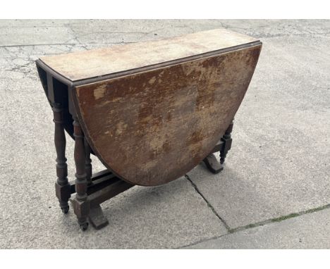 Oak gate leg table measures approximately Height 29 inches, Width 42 inches, Width 12 inches 