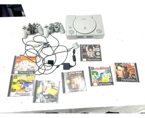 Playstation One with controllers and 7 games, untested, to include Star Wars, Monopoly, War zone etc all untested 