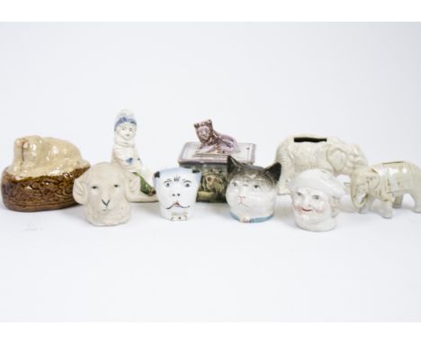 A collection of 19th and 20th Century ceramic money boxes, including examples modelled as elephant, ram's head, child on a to