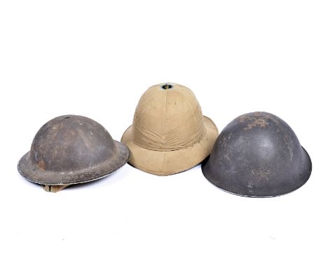 A British Brodie helmet, with original liner, together with British Turtle pattern helmet, with original liner, plus Pith hel