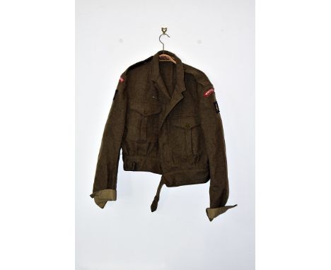 A 1949 pattern battledress blouse, having Worcestershire Regt badges, together with a DPM Field jacket, a late 20th Century h