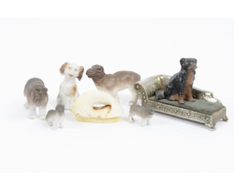 A collection of ceramic figures, including elephant, hippopotamus, rhinoceros, and dogs, together with a Russian wooden egg d