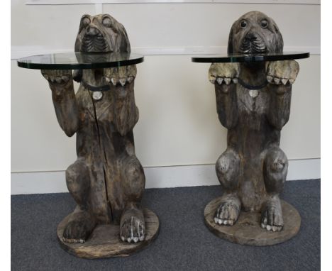 A large pair of carved wooden console tables modelled as begging dogs, glass circular tables, 112 cm high x 50 cm diameter (2