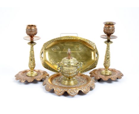 A pair of William Tonks &amp; Sons brass and copper candlesticks, 18.5 cm high, and matching chamberstick, marked to base; to