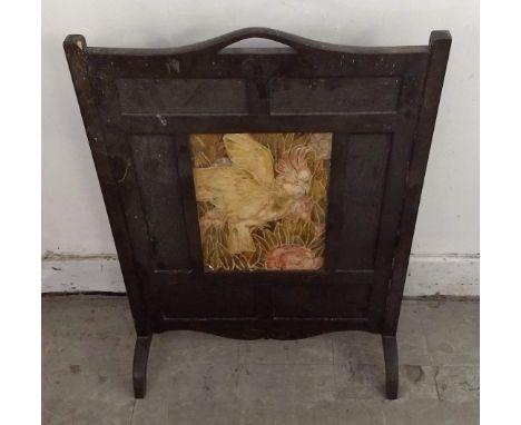 A 20th Century oak firescreen, central panel of cockatoo, 60 cm wide x 83 cm high
