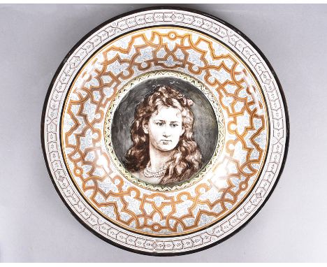 A 19th Century hand painted Wedgwood plate, having raised centre with portrait of a young woman, surrounded by an ornate tran