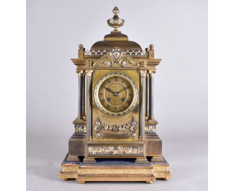 A W Gibson &amp; Co lacquered brass architectural mantel clock having floral swag, egg and dart design within a column fronta