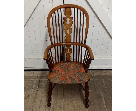 A stick back Windsor chair, turned supports united by stretcher