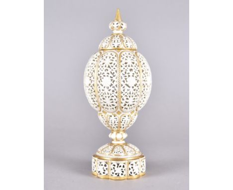 A Graingers Worcester reticulated urn and cover, the ovoid body of lobed form with decorative floral and scroll design having