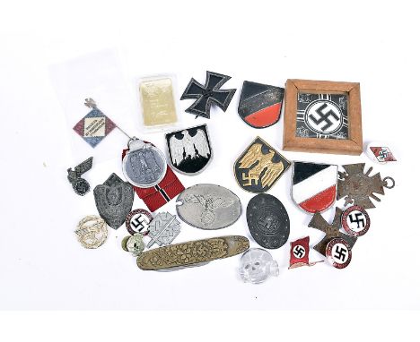 An assortment of German items, including Iron Cross marked L117 to pin, NSDAP badges, 21 Juni 1934 porcelain badge, a medal R