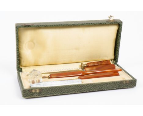 An early 20th Century cased pen set, amber Bakelite finish, comprising dip pen with George Hughes gold plated nib, ink pot, s